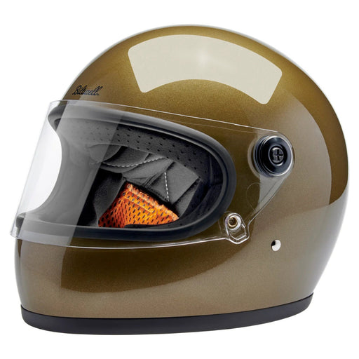 Gold motorcycle helmet with clear visor on a white background