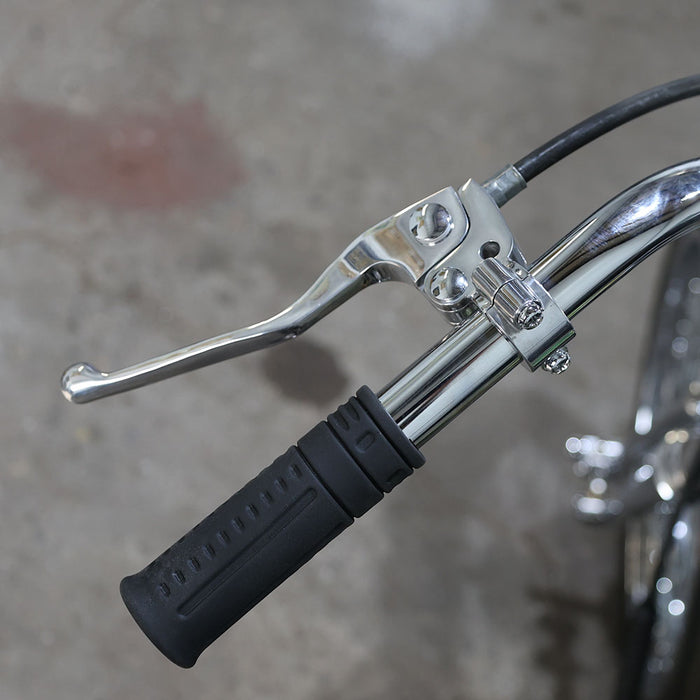 Close-up of a motorcycle handlebar with black grip and silver lever on a blurred background