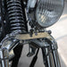 Close-up of a motorcycle headlight and chrome parts on a blurred background
