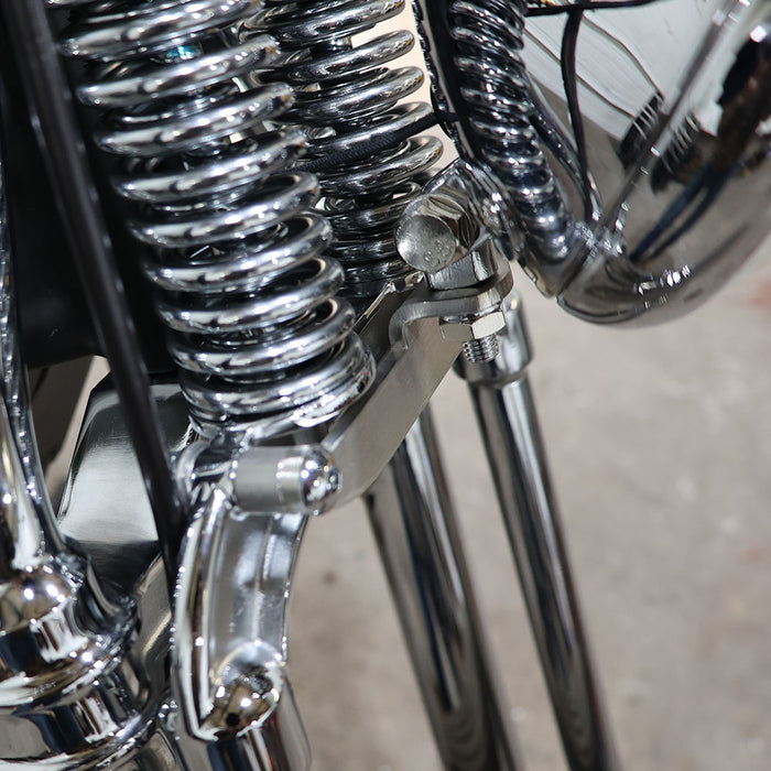 Close-up of a motorcycle's chrome suspension system.