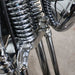 Close-up of a motorcycle's chrome suspension system.