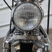 Close-up of a motorcycle headlight with chrome finish