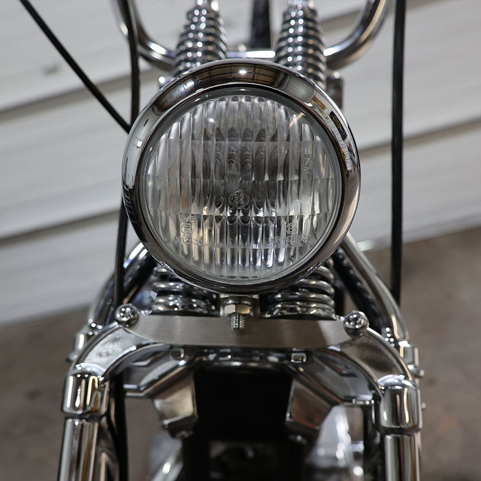 Close-up of a motorcycle headlight with chrome finish