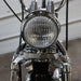 Close-up of a motorcycle headlight with chrome finish