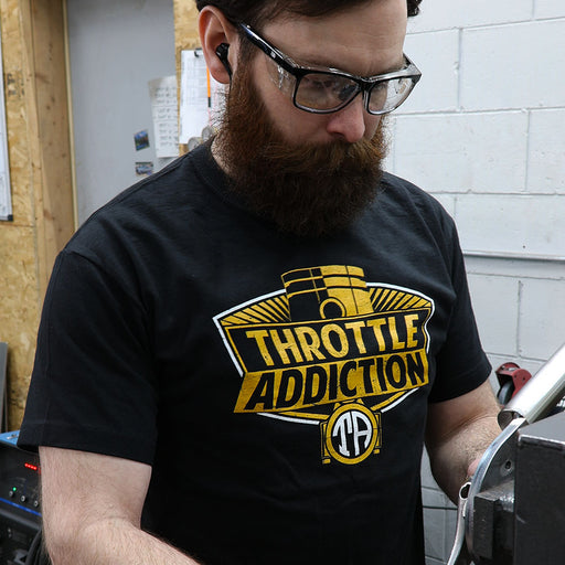 Man wearing black throttle Addiction piston logo in shop