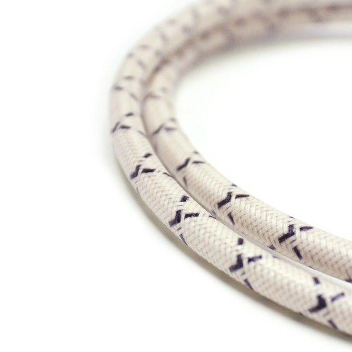 7mm solid core copper conductor, PVC wrapped and then covered in cotton wrap for that old school look.