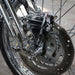 Close-up of a motorcycle wheel with chrome suspension and disc brake.