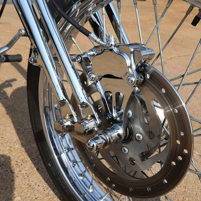 Close-up of a motorcycle wheel with metallic components on a blurred background