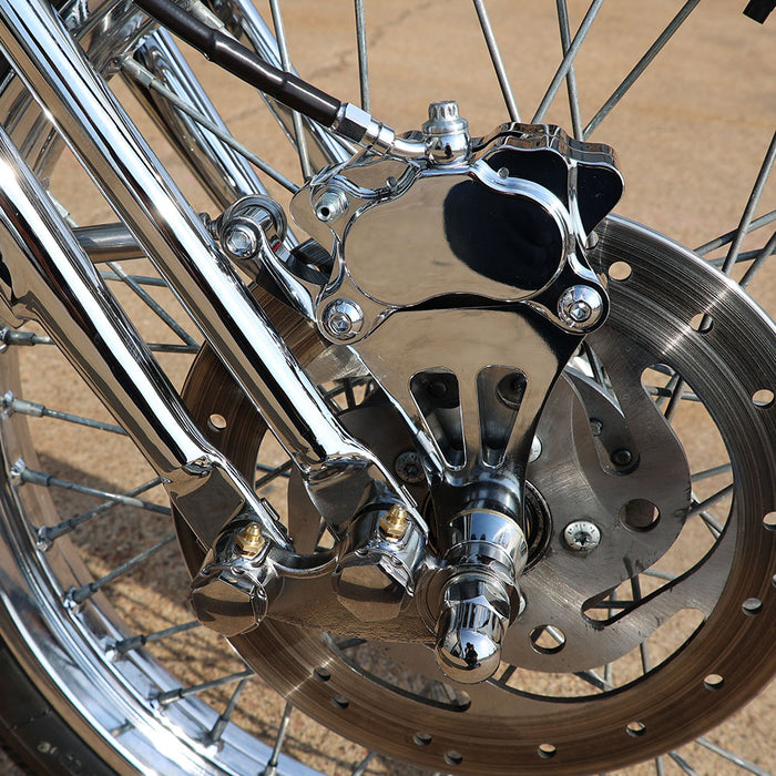 Close-up of a motorcycle wheel with metallic components on a blurred background