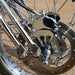 Close-up of a motorcycle wheel with metallic components on a blurred background