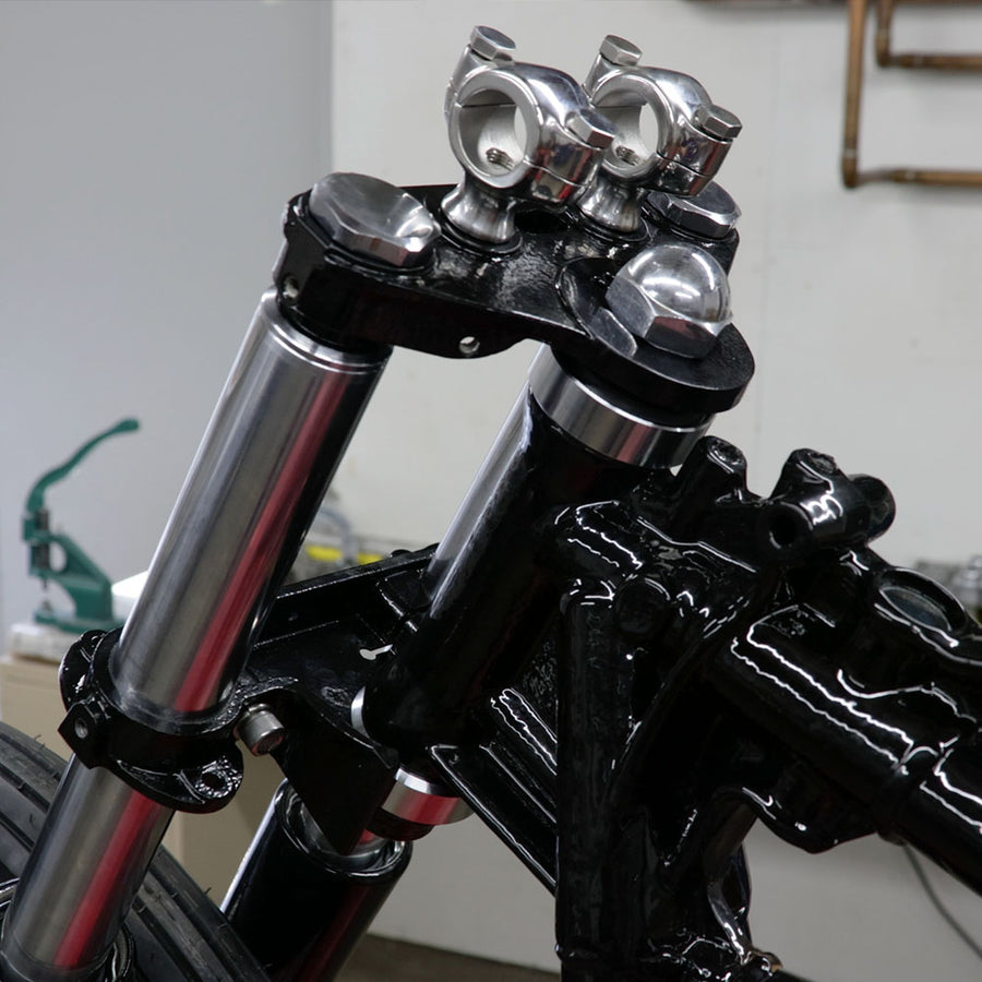 Close-up of a motorcycle's suspension system with a blurred background