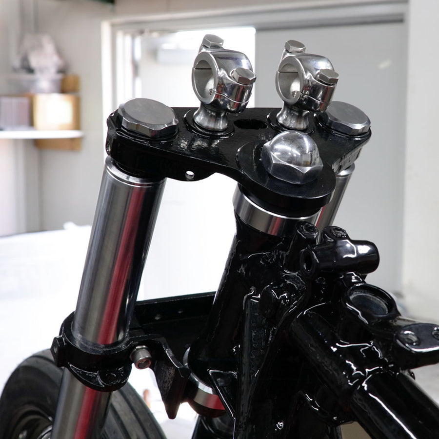 Close-up of a motorcycle handlebar with chrome accents