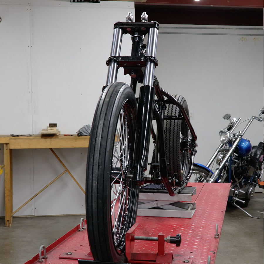Motorcycle on a lift in a garage setting