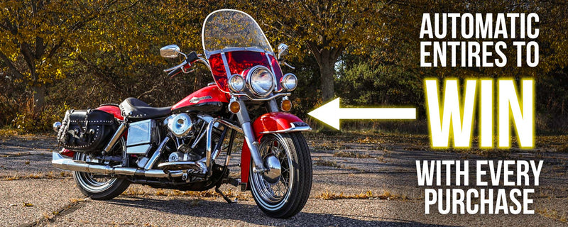 red motorcycle in front of fall leaves automatic entries to WIN with every purchase