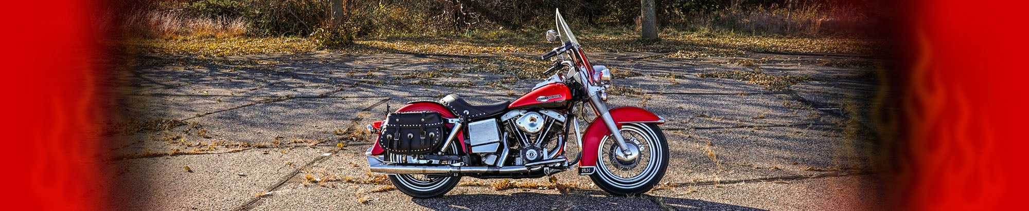 red motorcycle parked on grey pavement