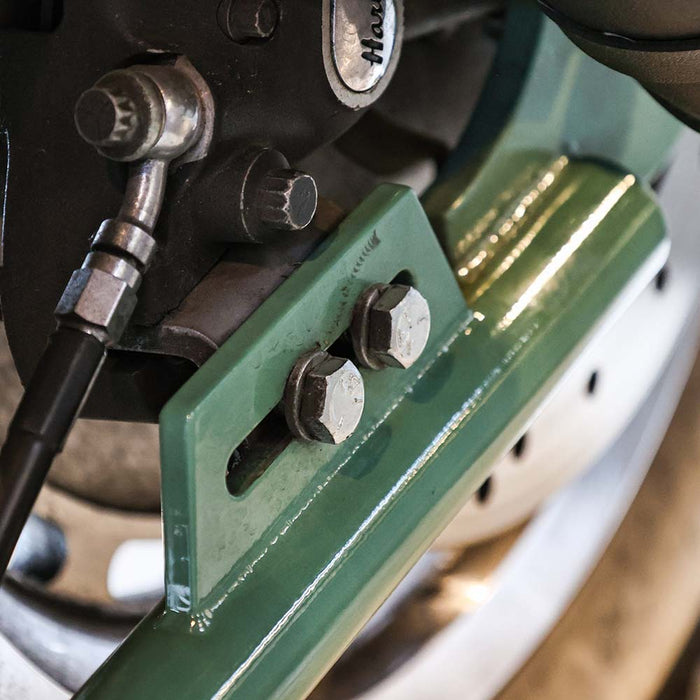 close up of brake caliper mounting bracket on sportster hardtail