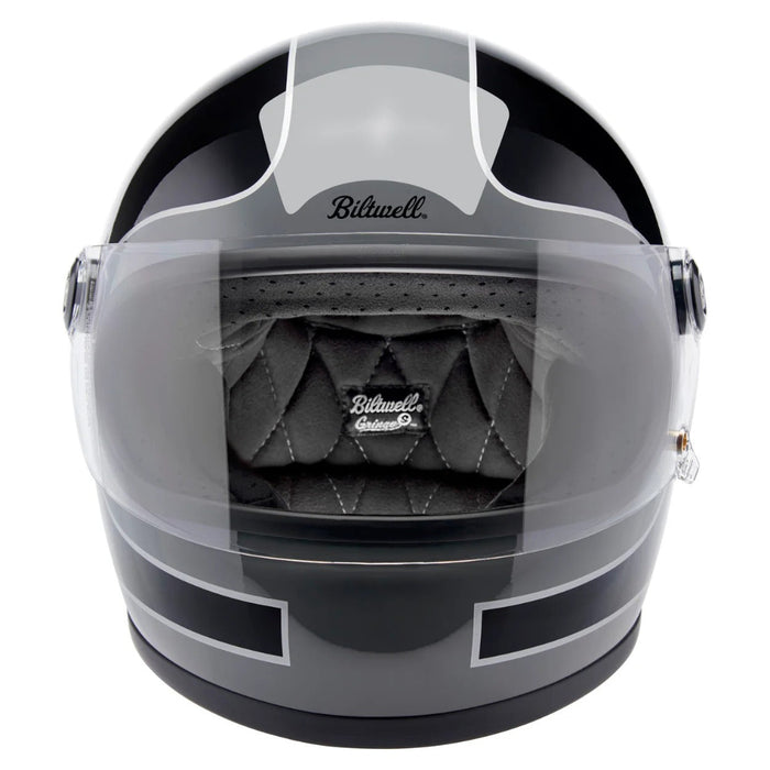 Gray motorcycle helmet with clear visor and quilted interior on a white background