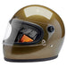 Gold motorcycle helmet with clear visor on a white background