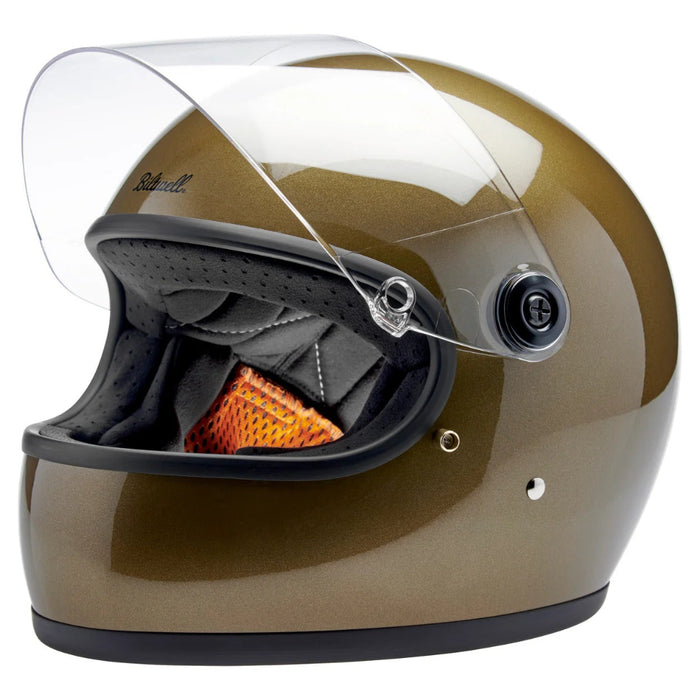 Gold  motorcycle helmet with clear visor on a white background