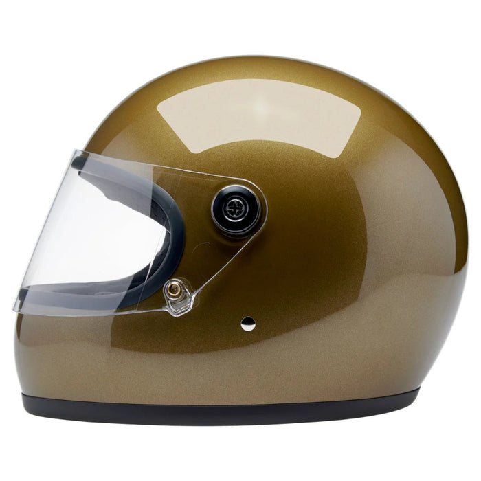 Gold motorcycle helmet with clear visor on a white background