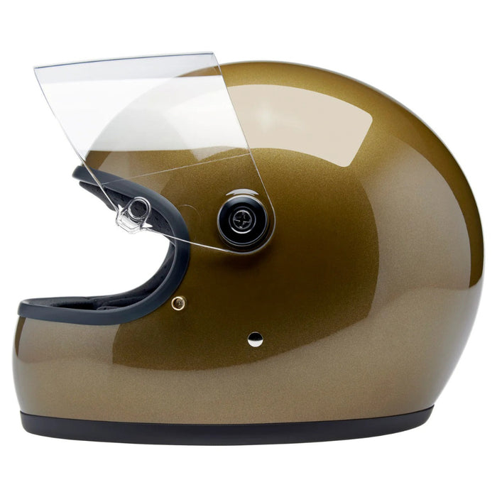 Gold motorcycle helmet with clear visor on a white background