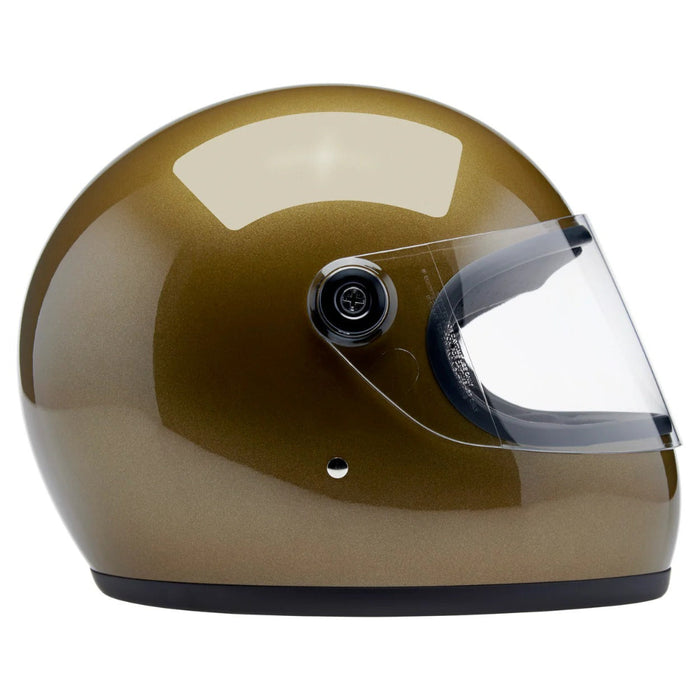 Gold motorcycle helmet with clear visor on a white background