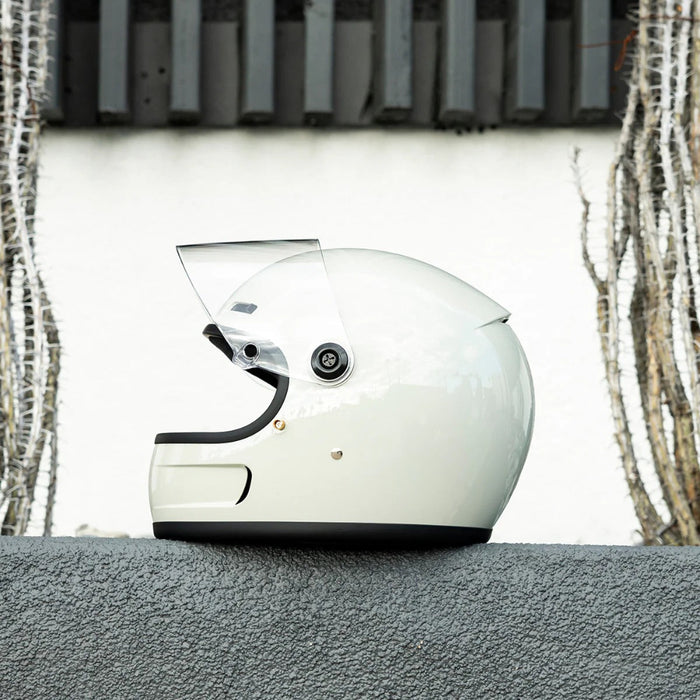 Gray motorcycle helmet on a gray surface with a neutral background