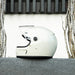 Gray motorcycle helmet on a gray surface with a neutral background